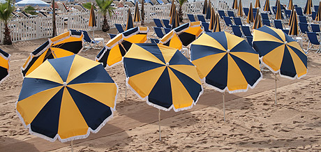 Beach umbrellas on shore of Cannes photo